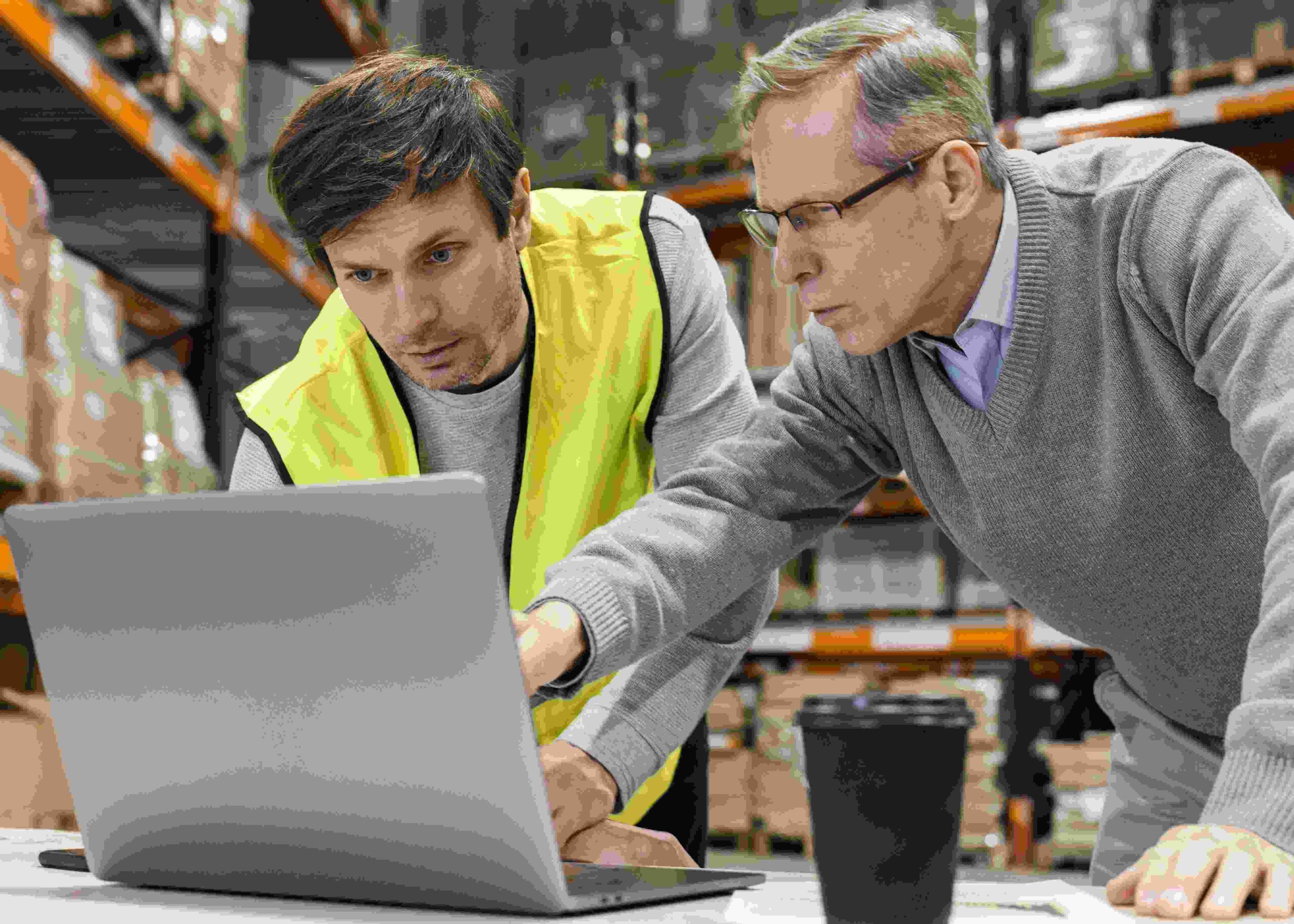 warehouse owner with employee checking inventory movement