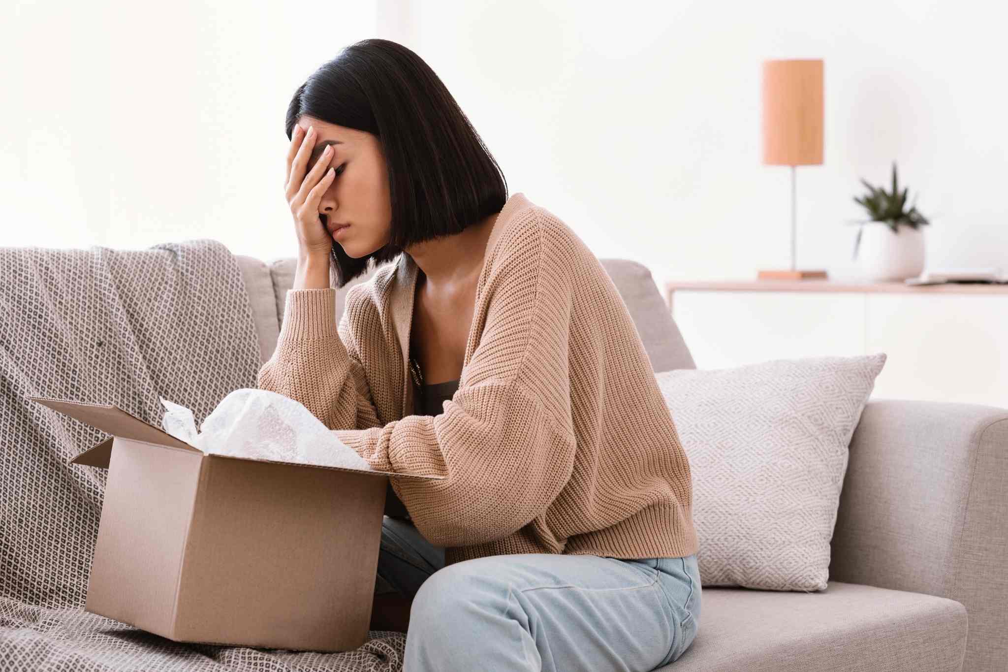 woman disappointed about the item inside the box