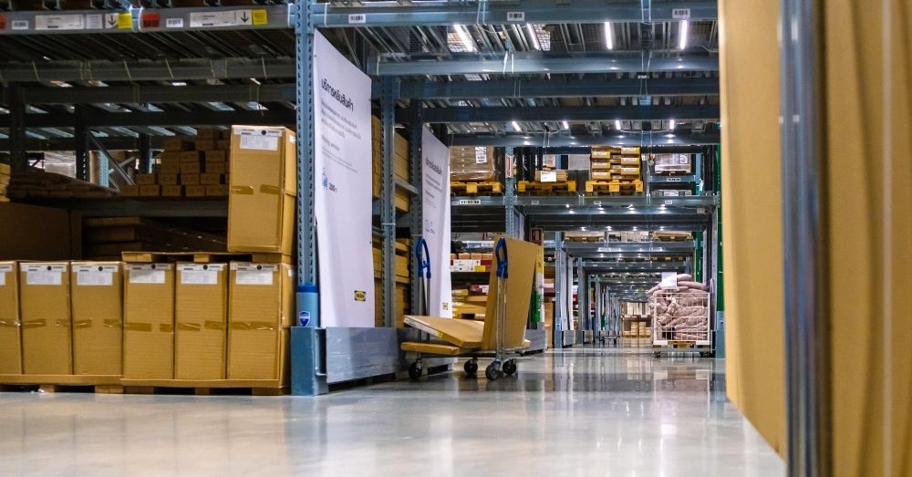 A warehouse aisle filled with tall racks and boxes.