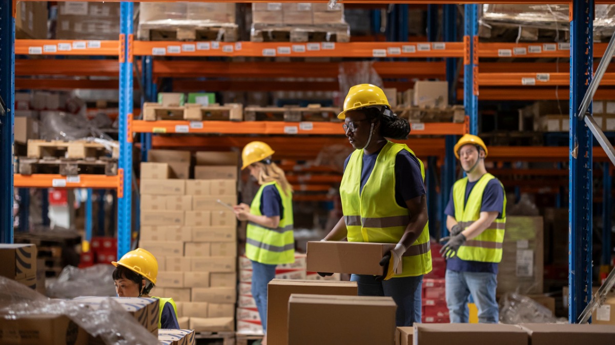 Warehouse workers wearing safety helmets 