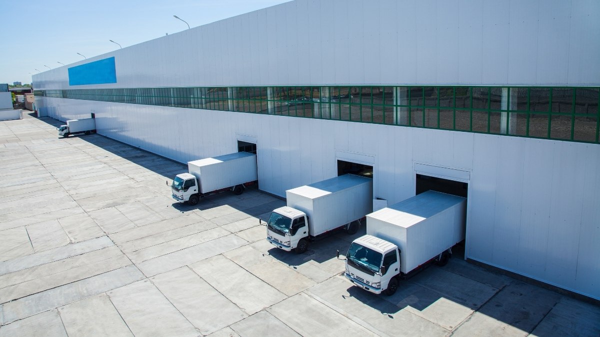 aerial view of several white delivery box trucks